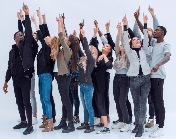 Casual group of excited friends with arms up isolated on white - Φωτογραφία, εικόνα