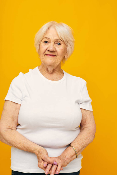 Photo of retired old lady posing face grimace joy yellow background - Φωτογραφία, εικόνα