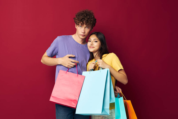 young boy and girl colorful bags shopping fun Lifestyle unaltered - Fotó, kép