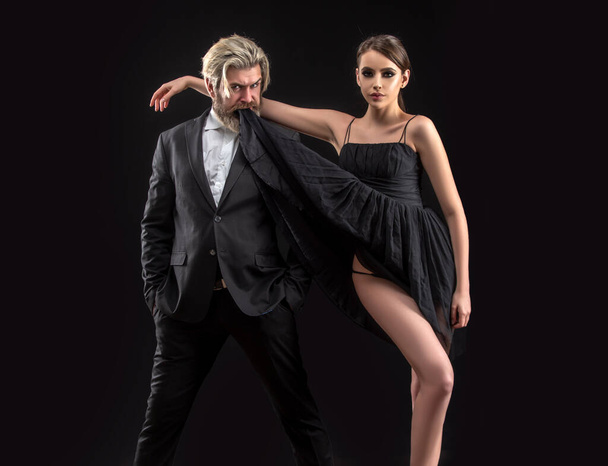 Salsa dancing couple. Young luxury pair dance isolated on black background. Romantic - Photo, Image