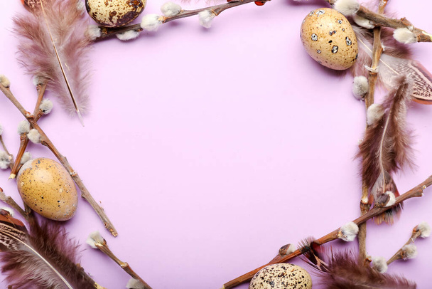 Stylish wreath with Easter eggs, willow branches and feathers on purple background - Photo, Image