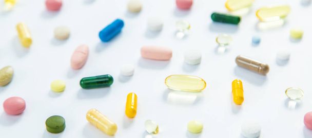 Supplements and vitamins on a white background. Selective focus. Medicine. - 写真・画像