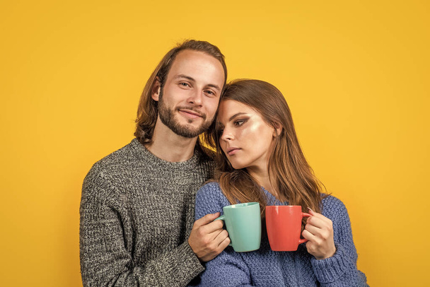 What a great morning. cozy and comfortable. knitwear fashion for family. couple in love drink tea. romantic relations of man and woman in winter. love can warm us. new year holiday and vacation - Фото, зображення