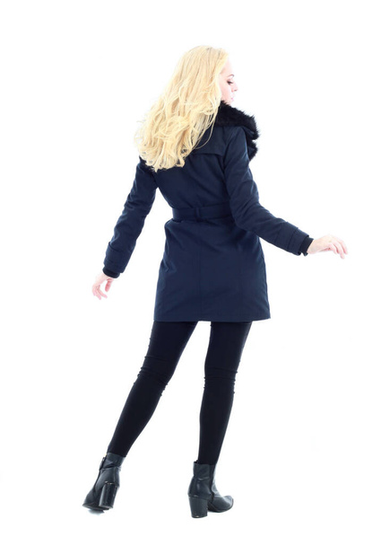 full length portrait of blonde woman wearing long winter coat. and casual clothes. standing pose, isolated on a white studio background. - Fotó, kép