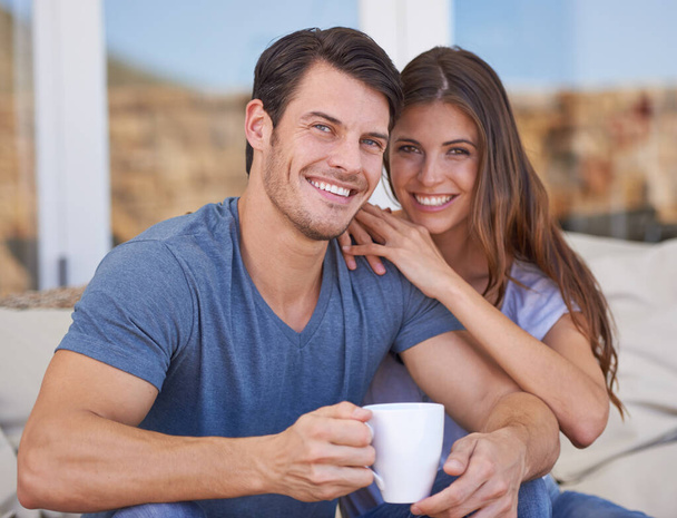 Total contentment. Shot of an affectionate young couple relaxing on the patio with coffee. - Foto, Imagem