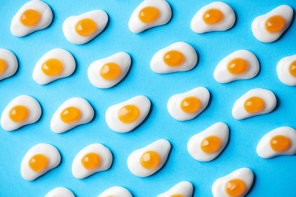 Egg shaped sweet marmalade on a blue background. Top view. - Φωτογραφία, εικόνα