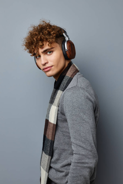 handsome guy plaid scarf wireless headphones technology isolated background - Фото, изображение