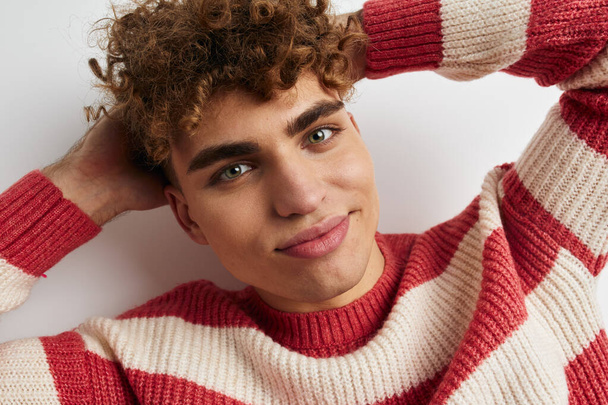 handsome guy in a striped sweater posing Lifestyle unaltered - Foto, Imagem