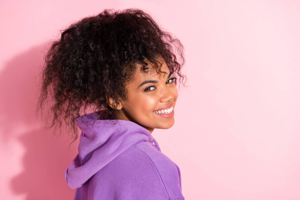 Photo of funny sweet african lady dressed purple hoodie smiling empty space isolated pink color background - Foto, imagen