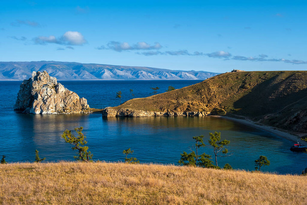 Shamanka Rock on lake Baikal near Khuzhir village at Olkhon island in September, Siberia, Russia. Lake Baikal is the deepest freshwater lake in the world. - Photo, Image