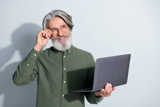 Portrait of handsome trendy cheery creative grey-haired man web designer using laptop ponder isolated over gray pastel color background - Φωτογραφία, εικόνα