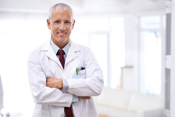 Your health is my number one priority. Portrait of a mature doctor standing with his arms crossed. - Foto, Imagem