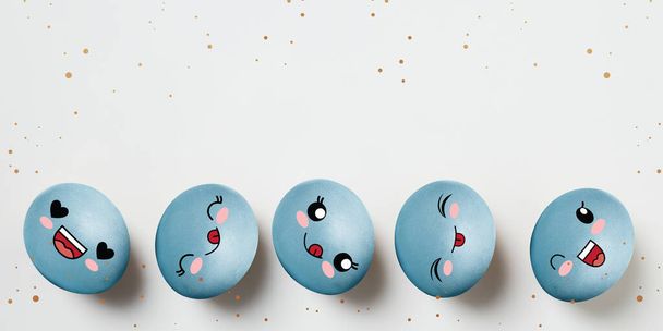 Blue painted funny cute eggs in cartoon style. Happy Easter traditions, mood. Concept of holidays, spring, celebrating, family time, kids, sales - Photo, Image