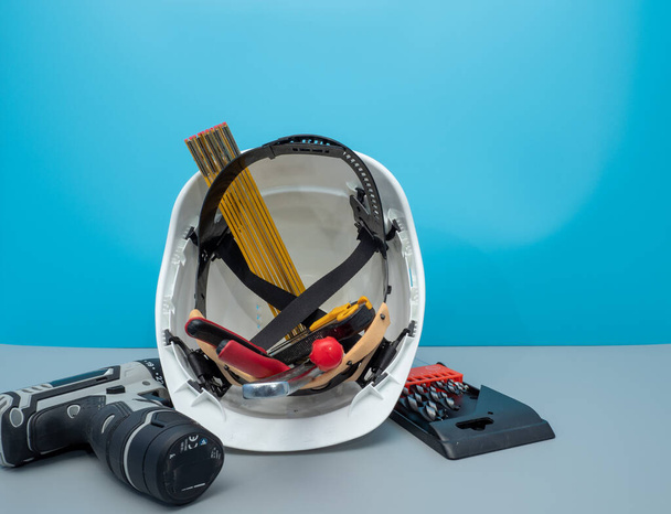 White construction helmet and construction tools. - Photo, Image