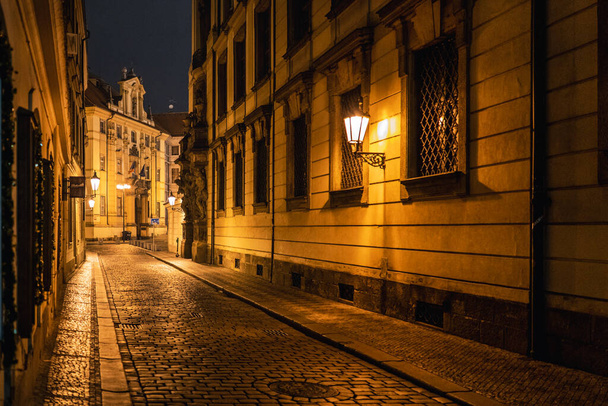 Old narrow street with stone road and lanterns in Prague - Valokuva, kuva