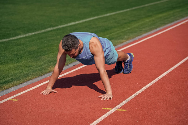 muscular guy stand in plank making push up on sport training, strength - Φωτογραφία, εικόνα