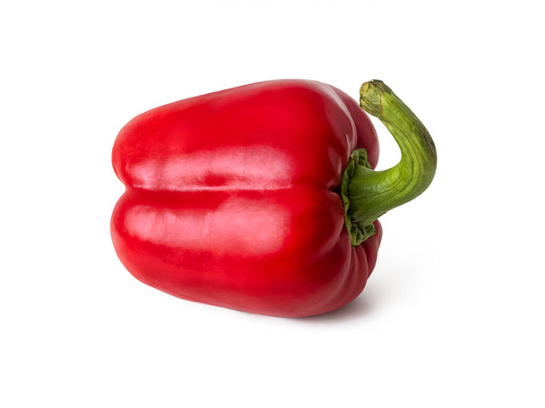 Red bell pepper with a shiny skin and a thick green peduncle, isolated on a white background - Photo, Image