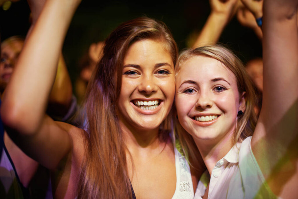 Having the time of their lives. Young girls in an audience enjoying their favourite bands performance. - Foto, immagini