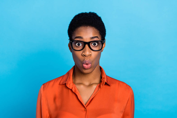 Photo of shocked funky lady unexpected discount reaction wear specs brown shirt isolated blue color background - Foto, Bild