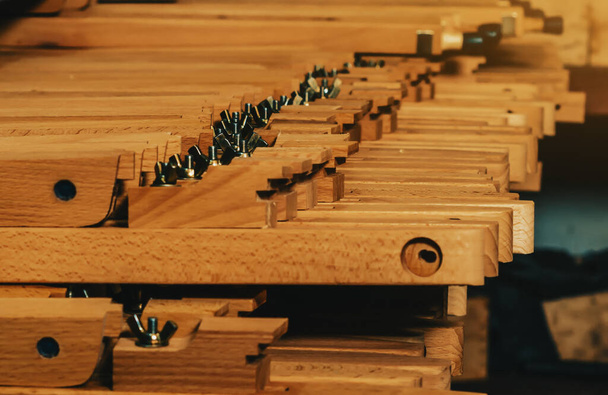 View of wooden legs to easels lying in row. Production of easels. Woodworking workshop. - Valokuva, kuva