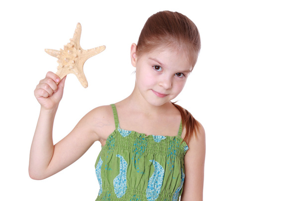 Little girl holding sea treasure - Foto, immagini