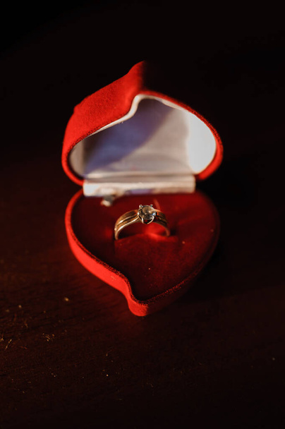 Golden ring with a stone in a red box - Photo, image