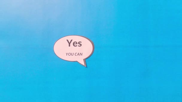 Human hand showing thumb up against motivation text written on speech bubble isolated on blue background. Conceptual image shows that you have the capability strength and ability to achieve goal. - Footage, Video