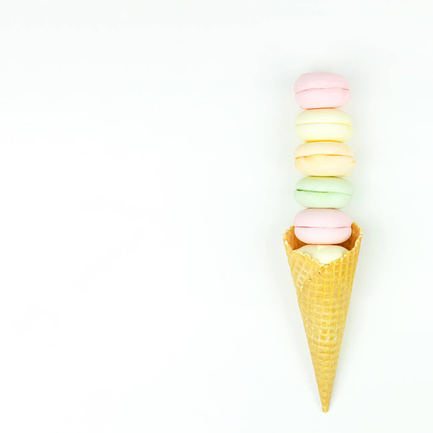 Wafer horn and marshmallow looks like macaroons on white, top view, flat lay, minimalist trend, concept of sweet dessert - Photo, Image