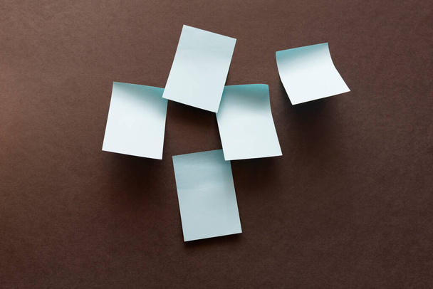blank blue stickers for notes on a dark surface - Photo, Image