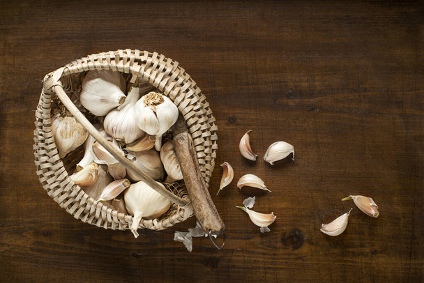 Garlic cloves on wooden vintage background - Фото, зображення