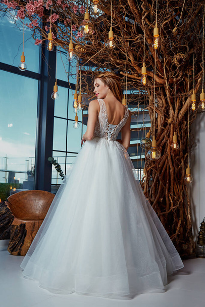 Beautiful woman bride fashion model brunette hair bright makeup pretty wear long silk white dress with lace bridal ceremony wedding espousal in blooming romance garden party marriage happy big day. - 写真・画像