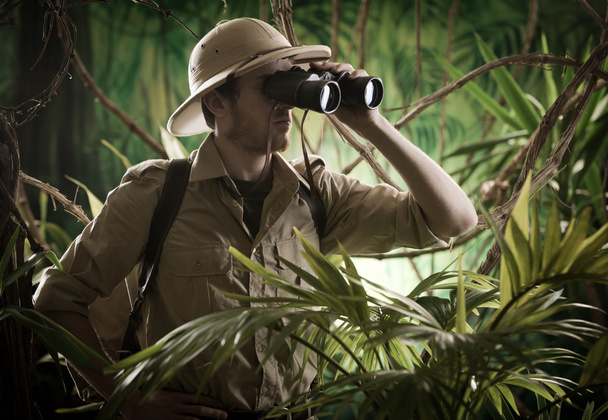 Explorer in jungle looking away - Foto, Imagen