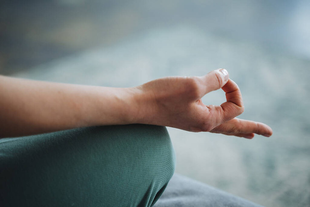 Meditation hand close-up, fingers fold the rite of mudra, yoga practice. Peace of mind, peace, love yourself, take care of your health. High quality photo - 写真・画像