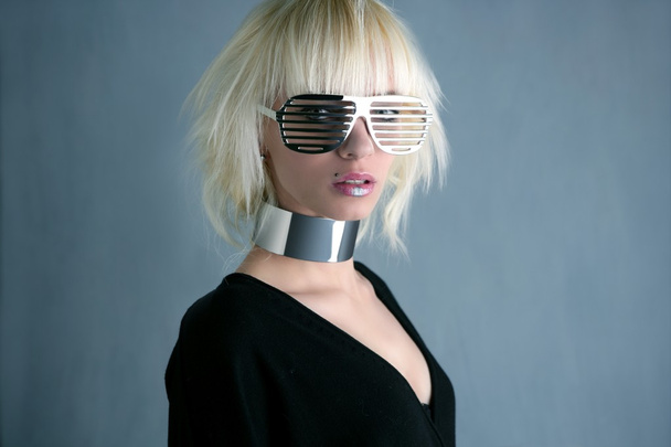 Blonde fashion futuristic silver glasses girl gray background - Foto, imagen