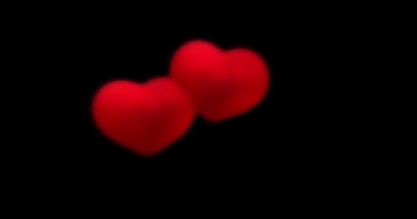 rode harten op een zwarte achtergrond. Valentijnsdag, liefde, jubileumvakantie, moederdag, 8 maart, vrouwenbruiloft, uitnodigings e-card. 4k videobeelden. mengmodus - Video