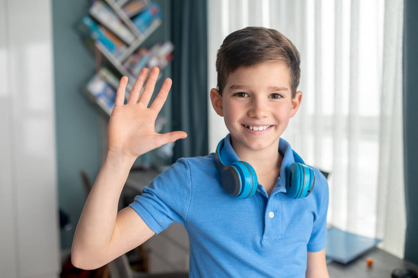 Cheerful nice kid standing in his room - Foto, Imagen