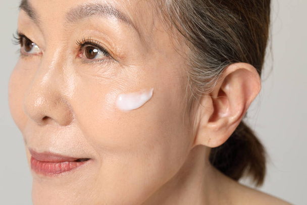 Asian Korean senior woman, basic skin care beauty concept in studio - Photo, image