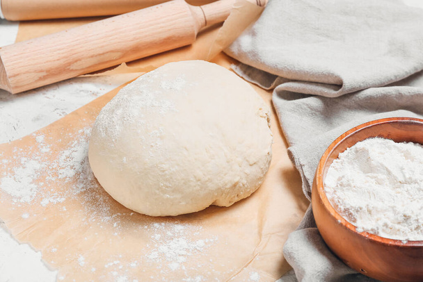 Raw dough with flour on table - Φωτογραφία, εικόνα