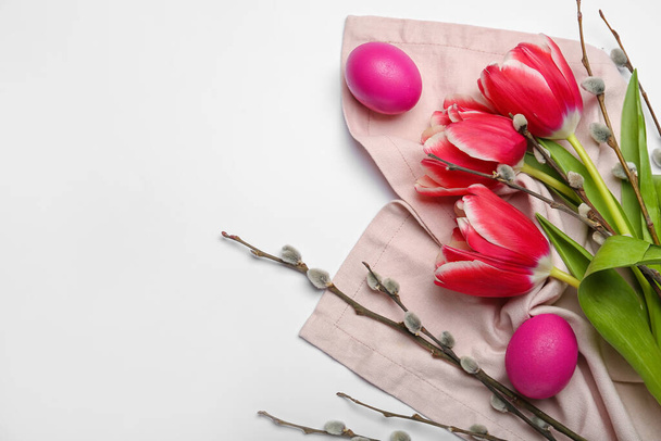 Pussy willow branches, painted Easter eggs and tulip flowers on light background - Фото, изображение
