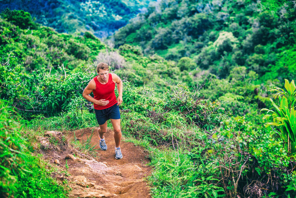 Trail running man athlete on marathon race. runner going up on mountain forest. Ultra running sport lifestyle - Zdjęcie, obraz