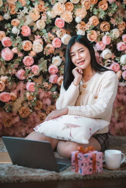 Portrait freelance business beautiful positive smile young asian woman girl wearing warm clothes online working with laptop computer with coffee cup mug at house home in the living room inside or cafe - Zdjęcie, obraz