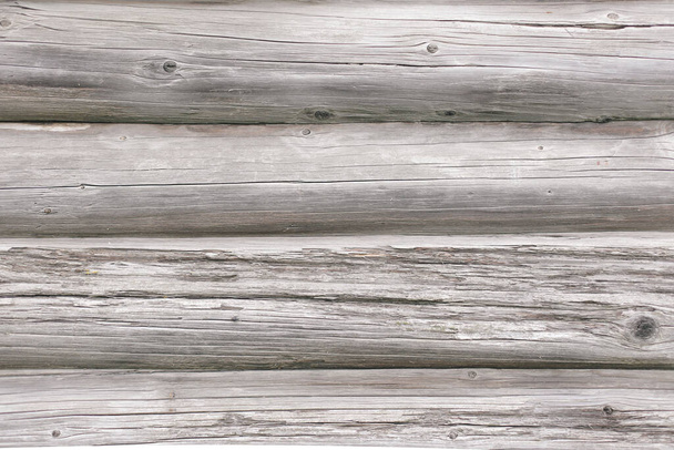 Fragment of a gray, old wall made of timber in full screen. - Фото, изображение
