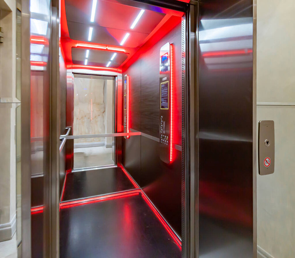 Wewnątrz kabiny windy z odbiciem lustra czerwonego światła. Zajrzyj do windy.. - Zdjęcie, obraz