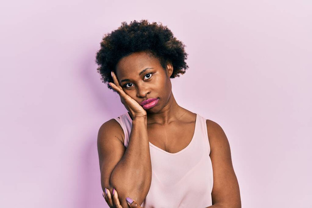Young african american woman wearing casual sleeveless t shirt thinking looking tired and bored with depression problems with crossed arms.  - Photo, image