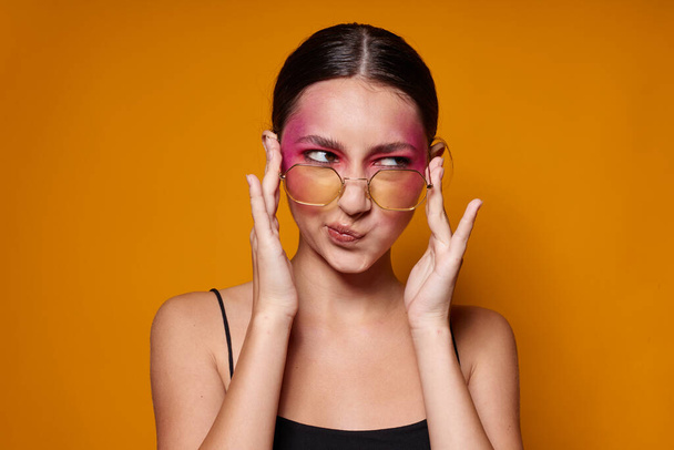 pretty woman fashion glasses pink face makeup posing attractive look isolated background unaltered - Foto, afbeelding