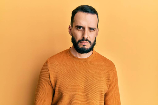 Young man with beard wearing casual winter sweater skeptic and nervous, frowning upset because of problem. negative person.  - Foto, Imagem