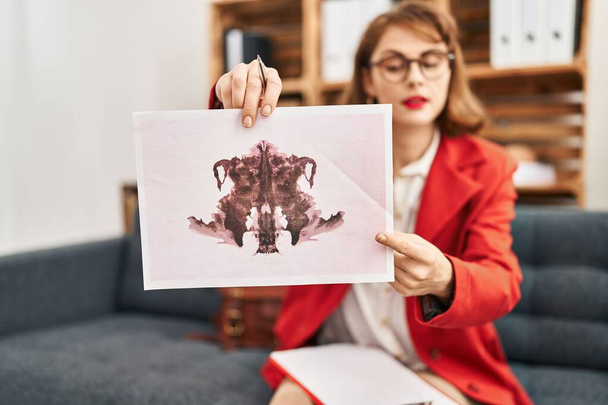 Young caucasian woman psychologist having rorscharch test at psychology center - Photo, Image