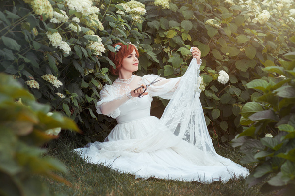 Girl with scissors makes the wedding dress. - Fotó, kép