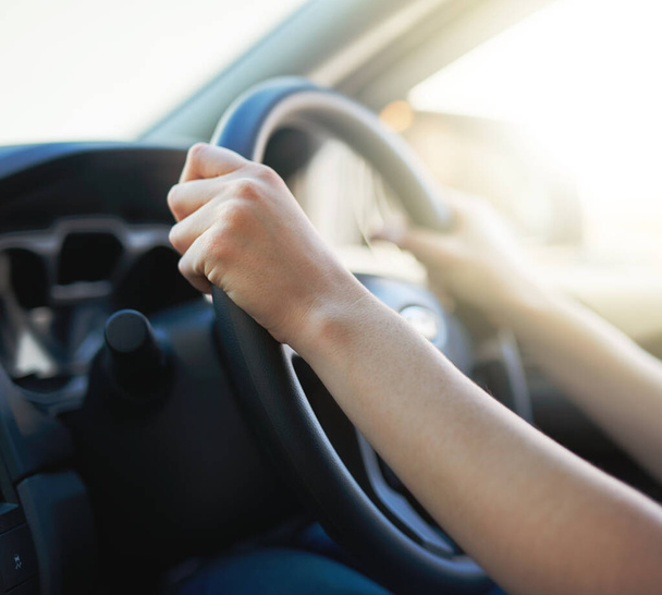 On route to her destination. Closeup shot of a woman holding onto a steering wheel while driving. - Foto, imagen