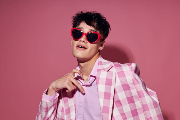 A young man self confidence pink plaid blazer fashion posing Lifestyle unaltered - 写真・画像